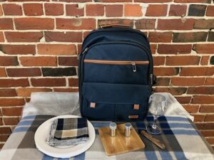 Blue Picnic Backpack with blanket, plates, napkins, cutting board, salt n pepper shakers, corkscrew and glasses
